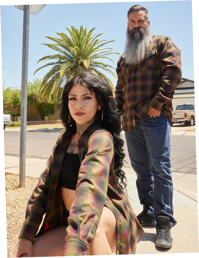A woman and a long-bearded man in Dixxon flannels on a street corner, from the Our Story page.