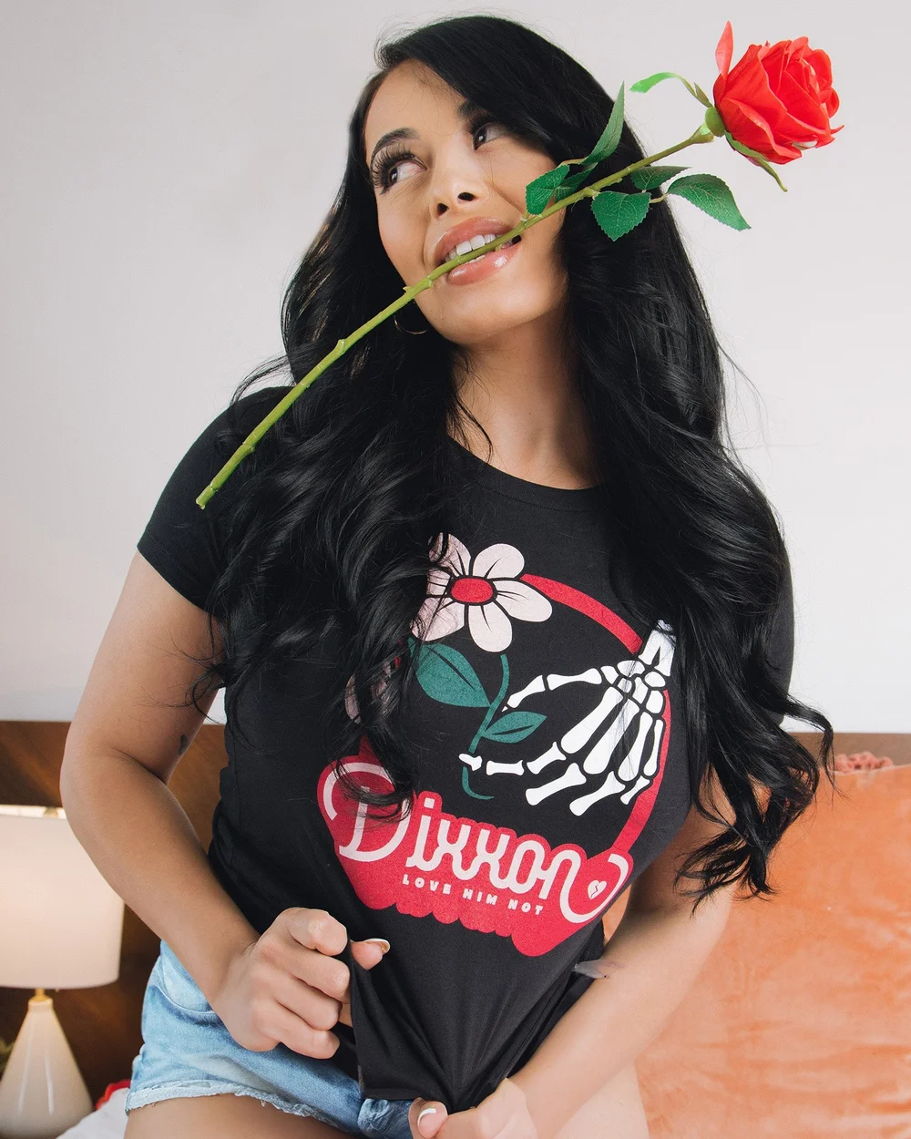 Women's Love Him Not Fitted Tee - Black, worn by a woman holding a rose.